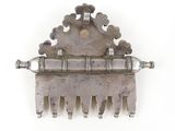 a silver comb with a bunch of silver beads on it