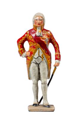 a figurine of a man in a red coat and white pants with a cane