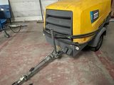 a yellow machine that is parked in a garage