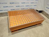 an image of a metal grate on top of a wooden pallet