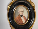 a picture of a man in an orange coat in a black and gold frame