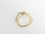 a close up of a gold ring on a white surface
