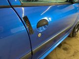 a close up of a car door handle with a sticker on it