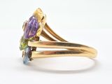 an image of a gold ring with an amethorate and multicolored stones