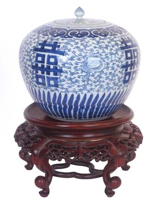 a blue and white vase sitting on a wooden stand