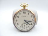 an image of a close up of a pocket watch on a white surface