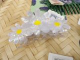 a bunch of plastic flowers that are sitting on a table