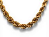 a close up of a gold necklace on a white background