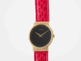 a close up of a red watch on a white background