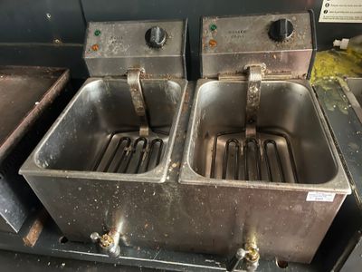 two stainless steel sinks sitting next to each other in a kitchen