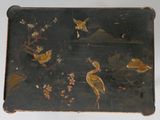 a black box with a painting of birds and flowers on it