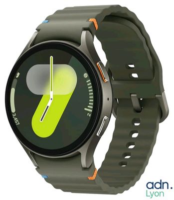 a smart watch with a green strap on it