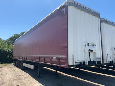 a semi trailer that is parked in the dirt