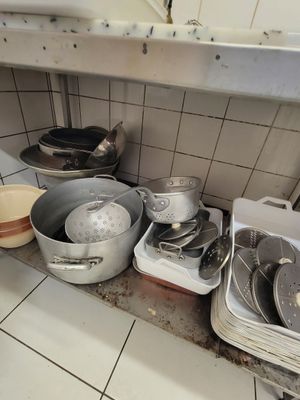many pots and pans on the counter in the kitchen