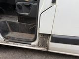 a white van with the door open on the side of the road