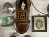 a clock that is hanging on the wall next to other items