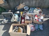 a lot of junk in a box on the ground