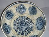 a blue and white bowl with a circular design on it