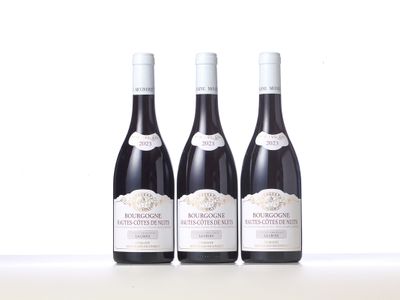 three bottles of wine sitting on top of a table next to each other