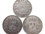 trois pièces d'argent sur lesquelles figure un blason