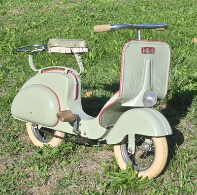 a scooter that is sitting in the grass on the ground