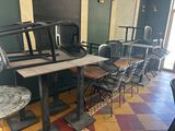 tables and chairs are lined up in a row in a restaurant