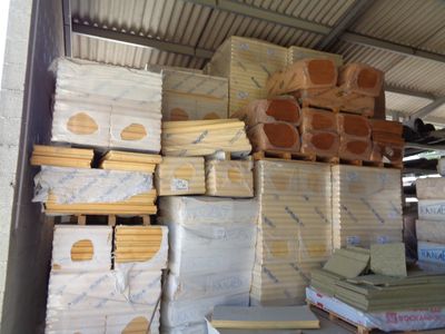 a large amount of wood stacked up in a warehouse