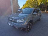 a picture of a grey dacia parked in a parking lot