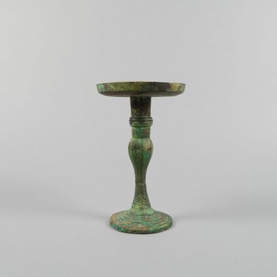 a small green table with a pedestal on top of it