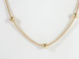 a close up of a gold necklace on a mannequin mannequin mannequin mannequin mannequin mannequin mannequin manne