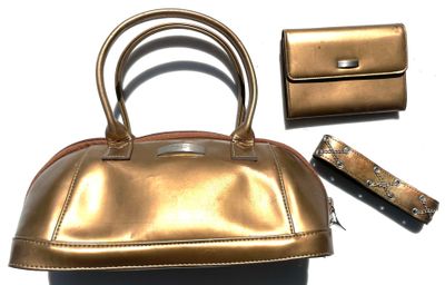 a gold purse and a wallet on a white surface