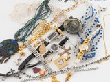 a lot of jewelry that is laying out on the table