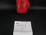 a close up of a red boxing glove on a black background