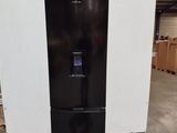 a black refrigerator sitting on a pallet in a warehouse