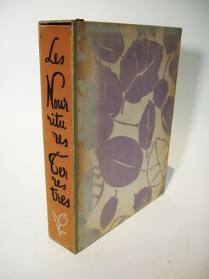 an old book sitting on top of a white table next to a white wall