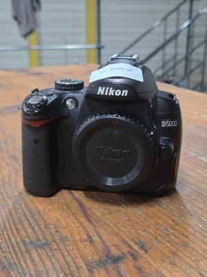 a camera sitting on a wooden table with a blurry background