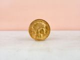 a gold coin sitting on top of a marble counter