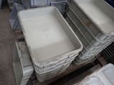 many plastic containers stacked on a pallet in a warehouse