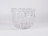 a close up of a clear glass vase on a white surface