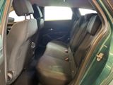 the back seat of a green car with the door open