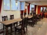 tables and chairs are lined up in a large room with red curtains