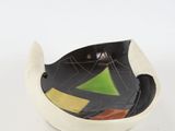 a black and white bowl with a green and yellow design on it