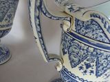 two blue and white vases sitting on a table