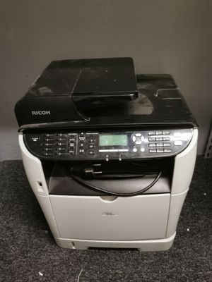 a black and white printer sitting on the floor