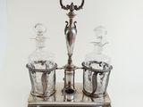 a silver plate with two glass bottles on it