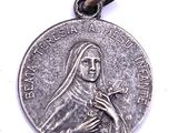 a close up of a silver medal with a woman holding a flower