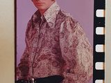 a picture of a man in a shirt and tie on the wall