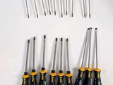a lot of screwdrivers that are laying on the table