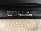 a close up of a black laptop on a white surface