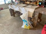 a bag of food sitting on a workbench in a garage